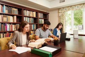 Three students studying in a library