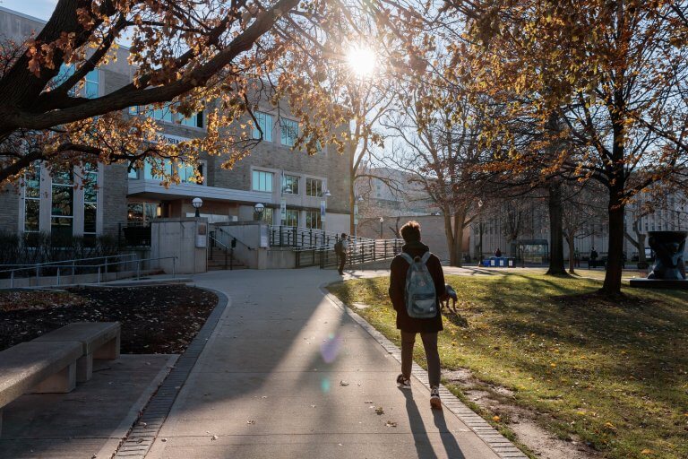 Student walking towards McMaster Museum of Art