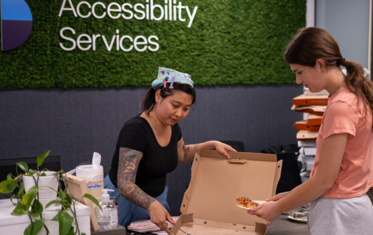 Serving pizza at Student Accessibility Services (SAS) event