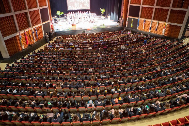 Overhead shot of graduates sitting in concert hall